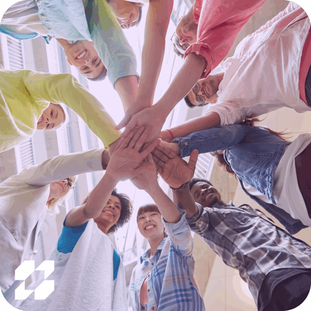 group of people joining hands seen from below
