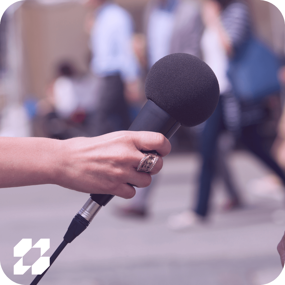 Hand holding out a microphone